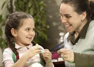 girl and mom sewing, istock photo